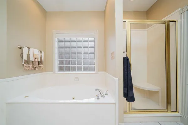 a bathroom with bathtub and window
