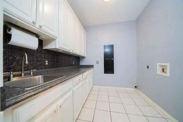 a kitchen with a sink and cabinets