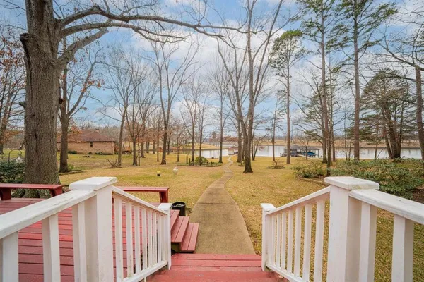a view of a house with backyard and trees