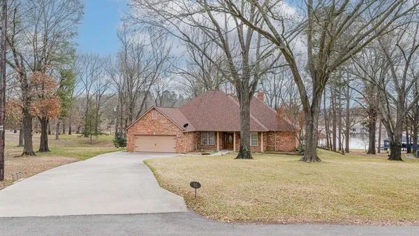 a front view of a house with a yard covered with snow