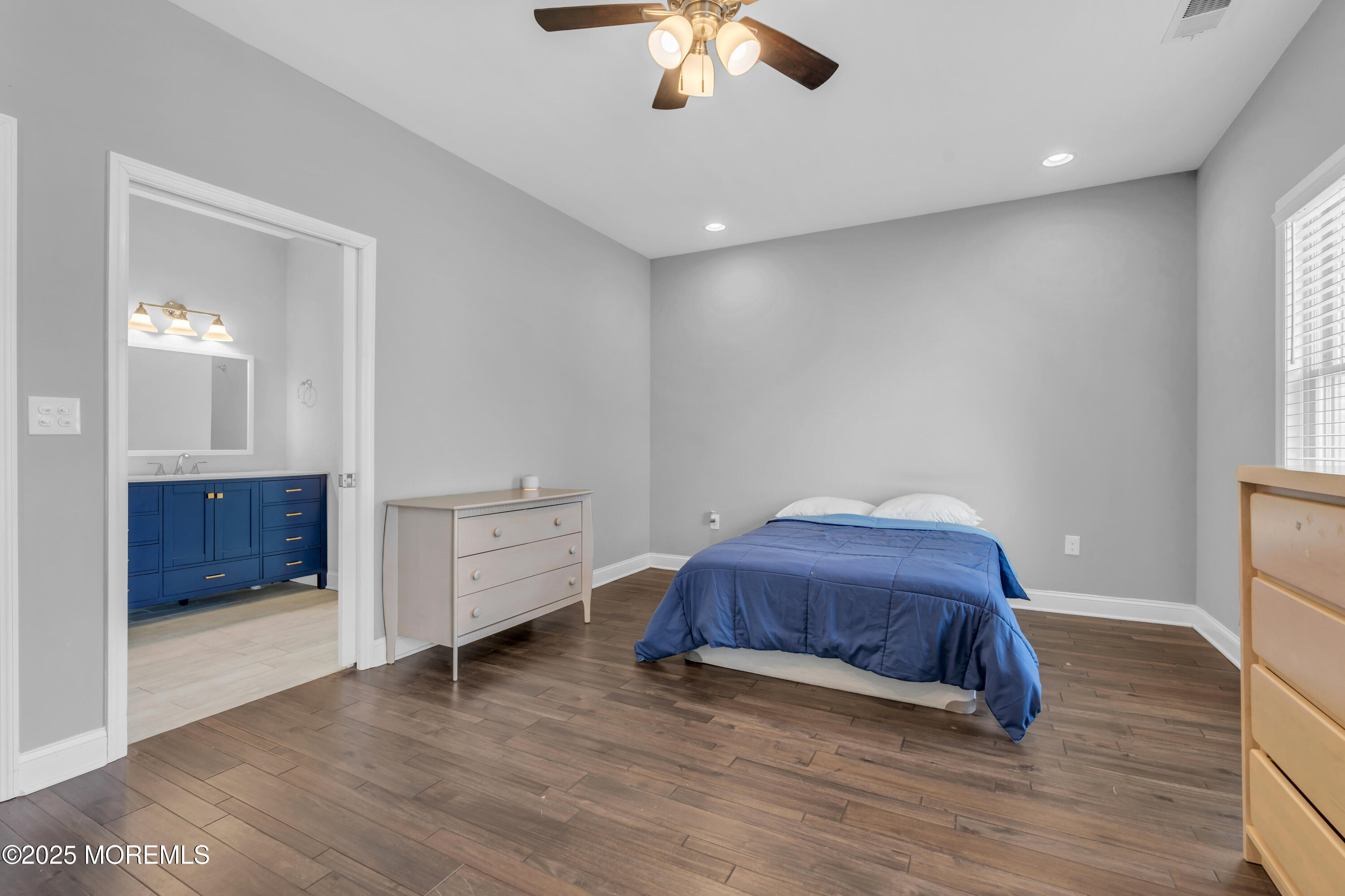 168 Pleasant Valley Road Morganville, NJ 07751 - Photo 35 of 61 a living room with a bed and a chandelier