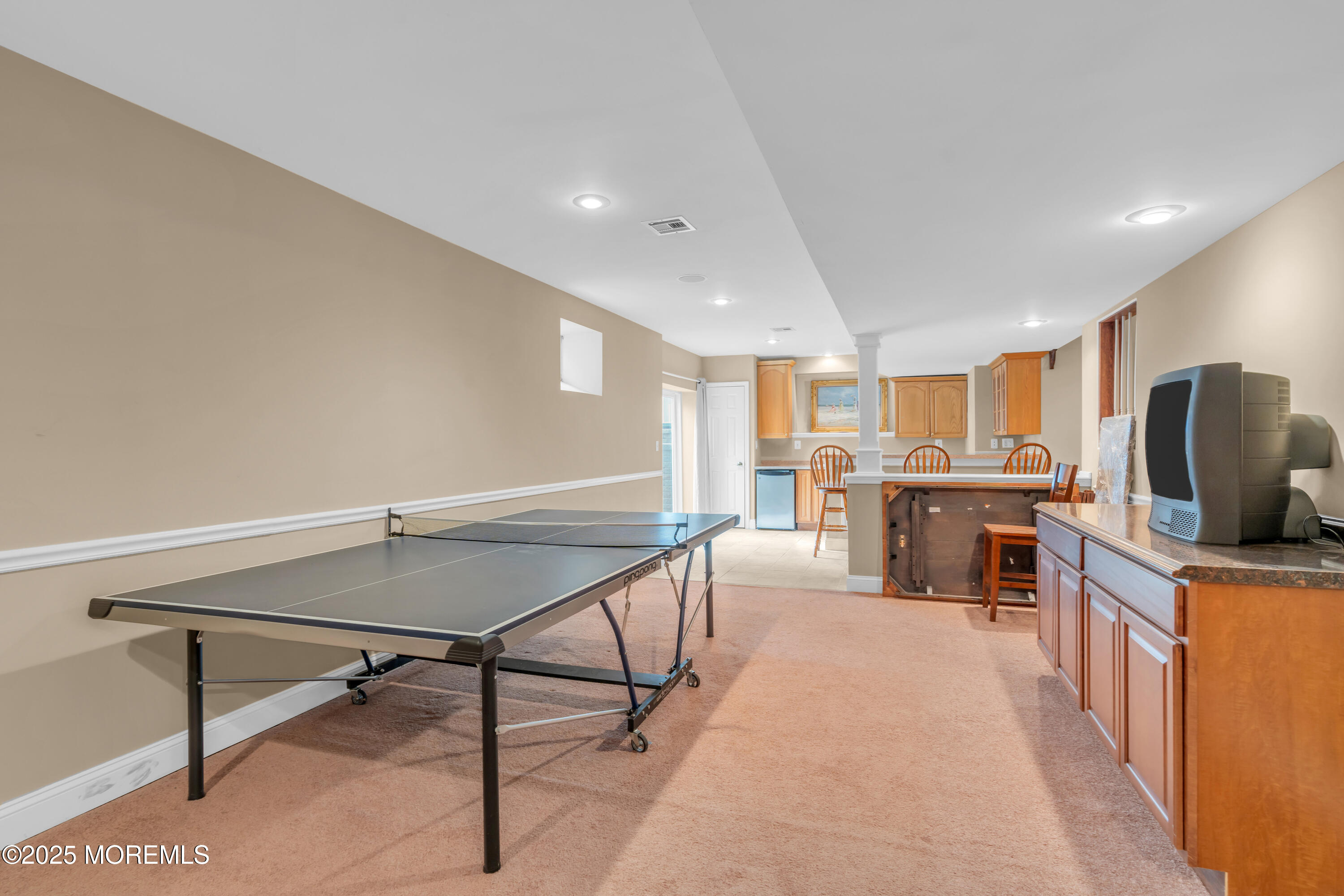 168 Pleasant Valley Road Morganville, NJ 07751 - Photo 54 of 61 a kitchen with stainless steel appliances kitchen island granite countertop a table chairs sink and cabinets