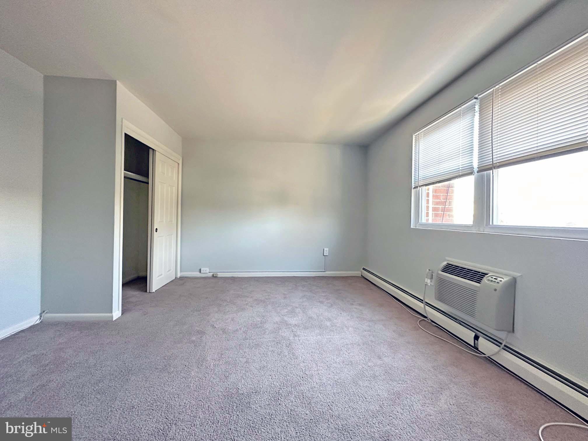 200 Spruce Street, Unit C8 Doylestown, PA 18901 - Photo 6 of 11 an empty room with windows and closet