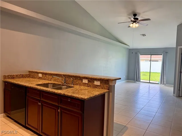 a view of a kitchen with a sink and a stove top oven