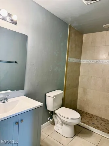 a white toilet sitting next to a bathroom sink