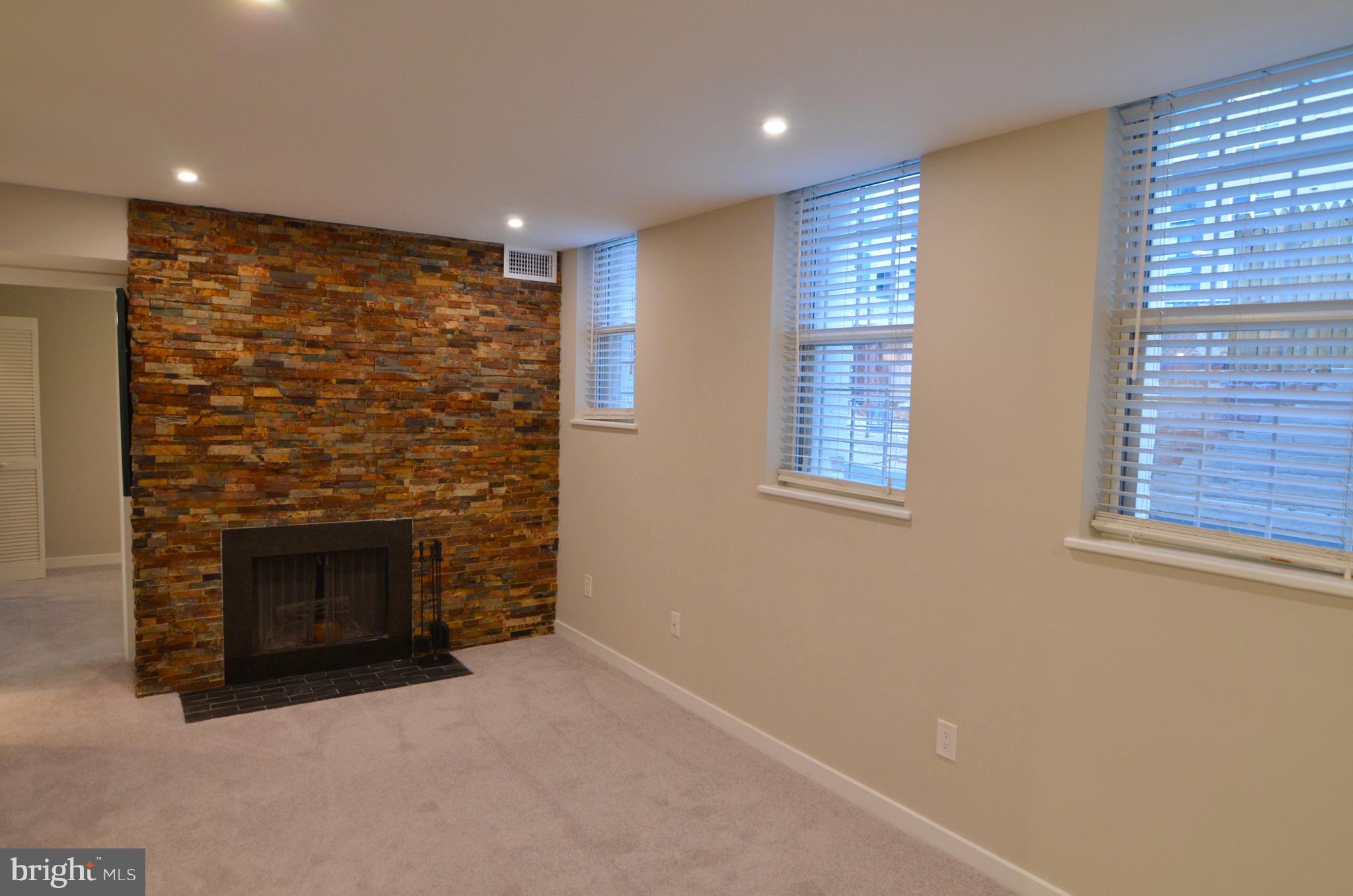 2114 N Street Northwest, Unit 2 Washington, DC 20037 - Photo 8 of 24 a view of an empty room with a fireplace and a window