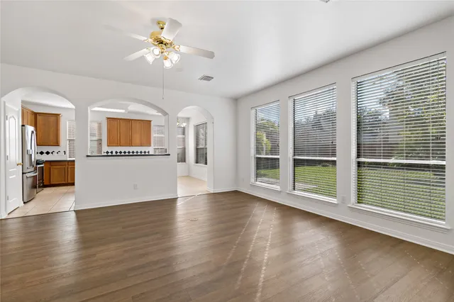 an empty room with windows and closet