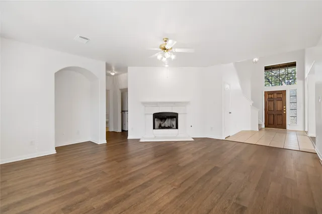 a kitchen with stainless steel appliances granite countertop a refrigerator a sink dishwasher a stove with wooden cabinets