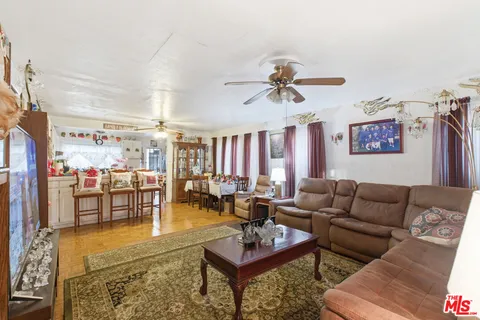 a living room with furniture a rug and a chandelier