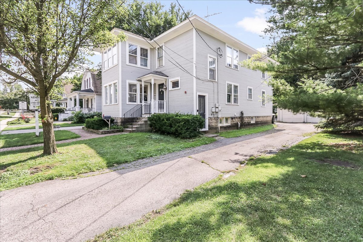 124 Harrison Street Barrington, IL 60010 - Photo 3 of 33 a front view of a house with a yard and trees