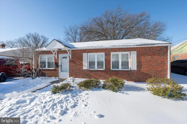 a front view of a house with a yard and outdoor seating