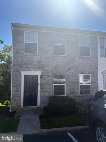 a brick building with a yard in front of it