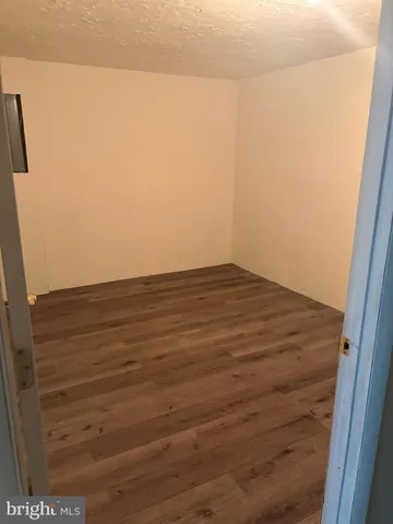 a kitchen with granite countertop a refrigerator and a sink