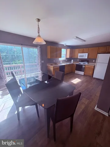 a view of a roof deck with wooden floor and fence