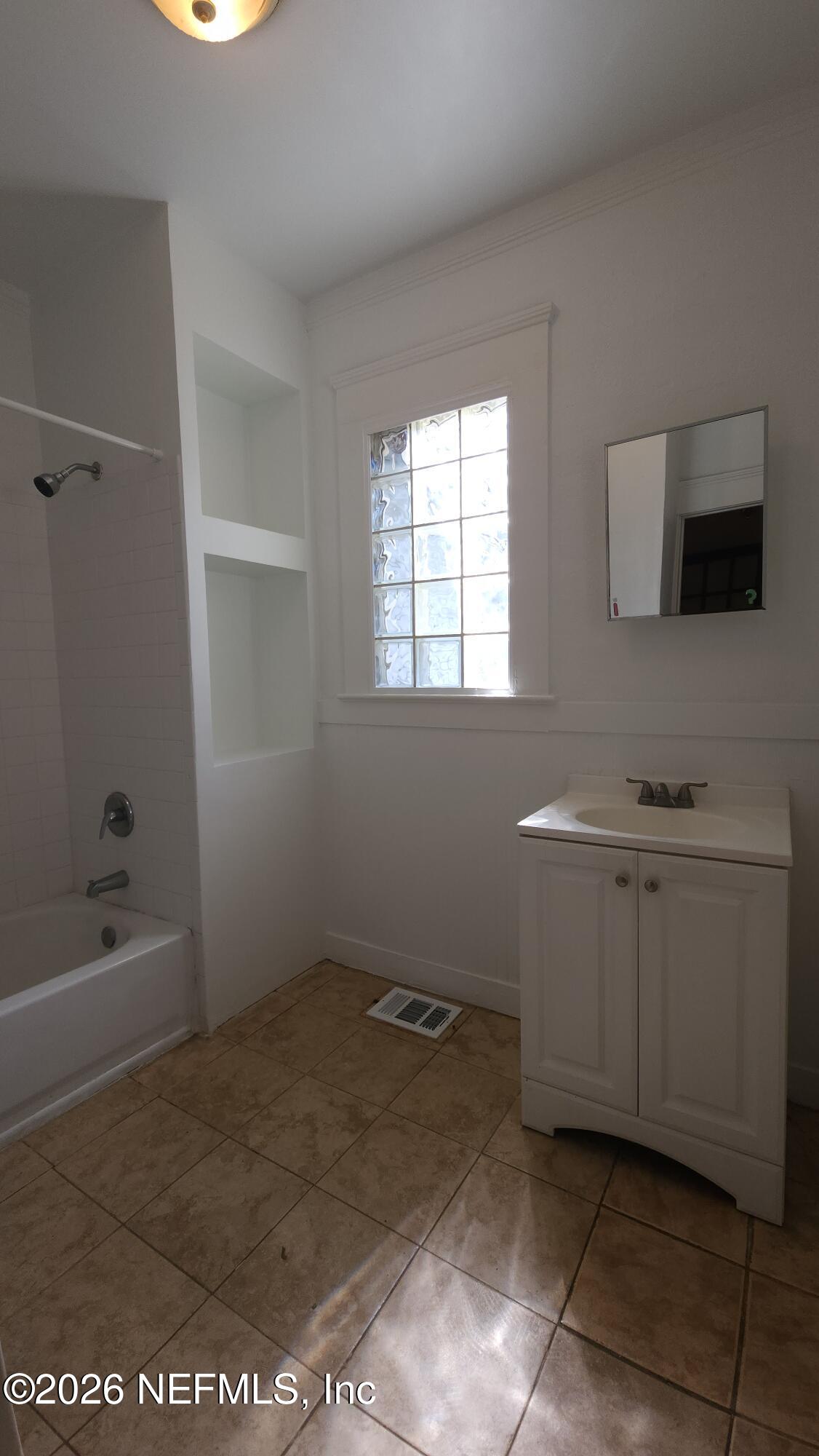 2036 Moncrief Road Jacksonville, FL 32209 - Photo 23 of 32 a bathroom with a sink a toilet and bathtub