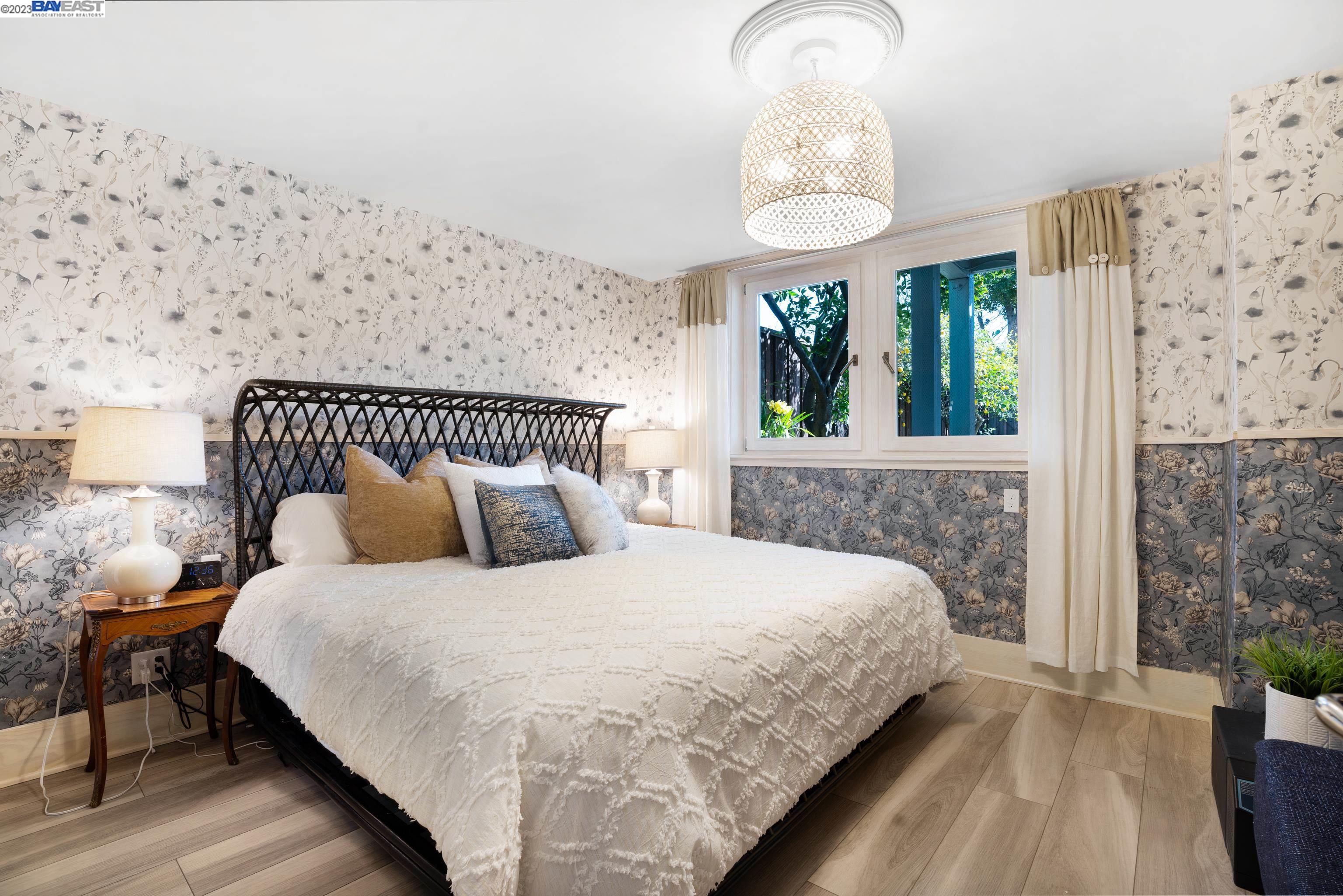 Undisclosed Address Alameda, CA 94501 - Photo 28 of 50 a bedroom with a bed and a chandelier