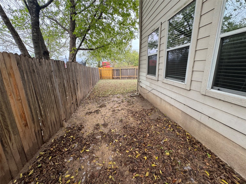 2053 Rachel Lane Round Rock, TX 78664 - Photo 33 of 37 a view of a backyard with large trees and wooden fence