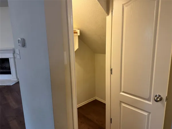 a view of kitchen with cabinets wooden floor and stainless steel appliances