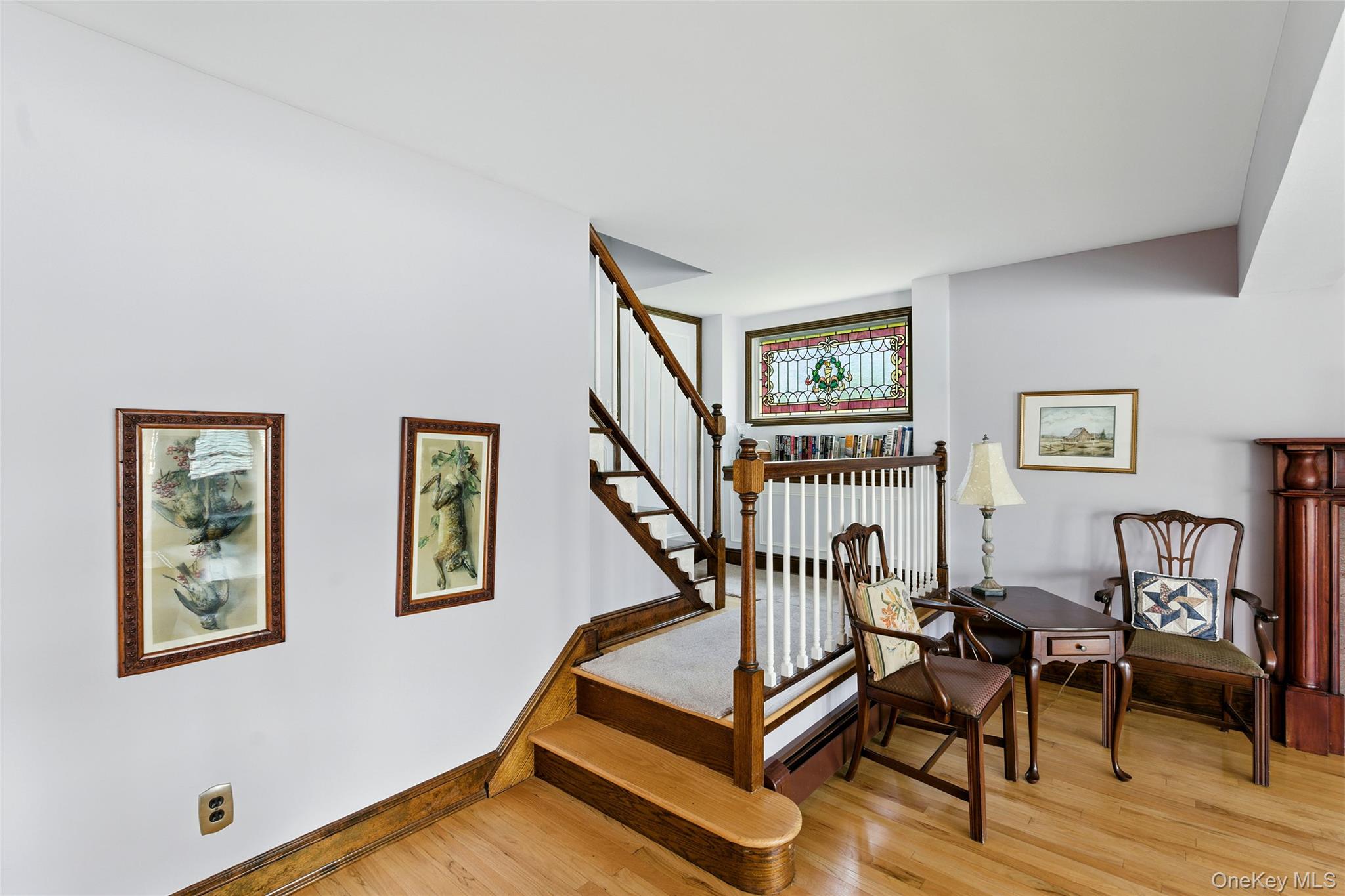 2005 Westview Drive Mattituck, NY 11952 - Photo 29 of 45 a living room with furniture stairs and a window