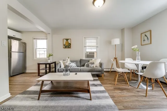 a living room with furniture a window and a table