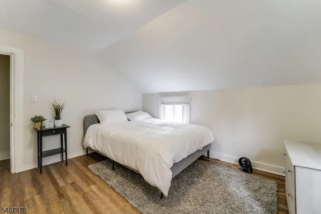 a bedroom with a bed and a table