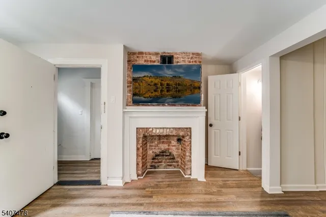 a view of a livingroom with a fireplace and window