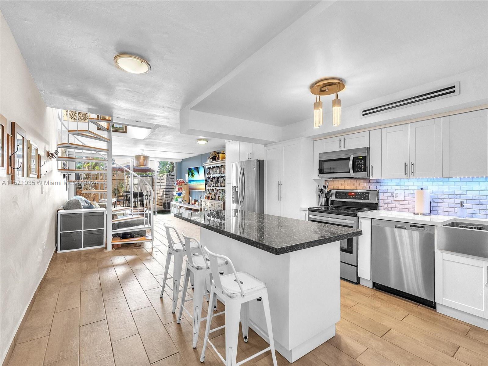 a kitchen with stainless steel appliances granite countertop a stove oven and a sink with granite countertops