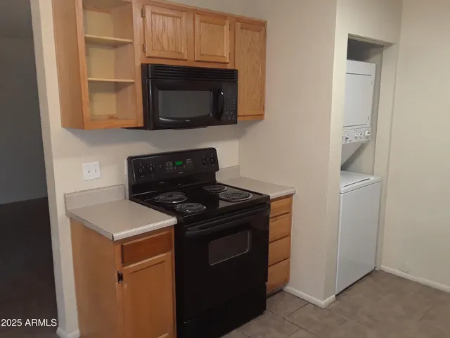 a kitchen with stainless steel appliances a stove a microwave a sink and cabinets