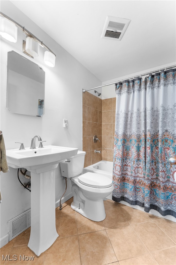 1515 Deville Avenue Northwest Canton, OH 44708 - Photo 11 of 42 Full bath featuring tile patterned flooring and shower / tub combo with curtain