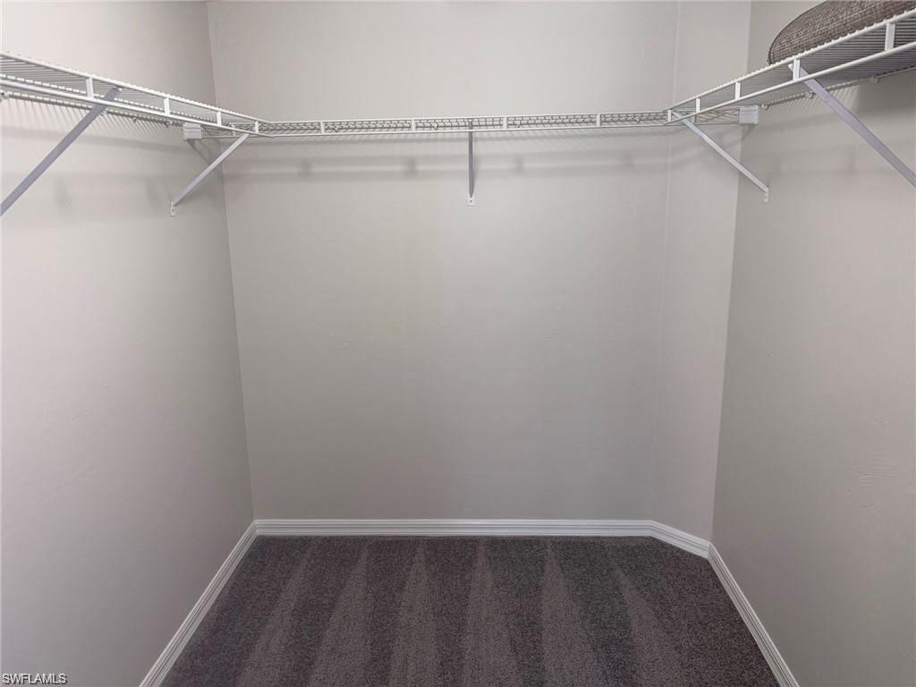 1915 Courtyard Way, Unit G102 Naples, FL 34112 - Photo 7 of 16 a view of an empty walk in closet