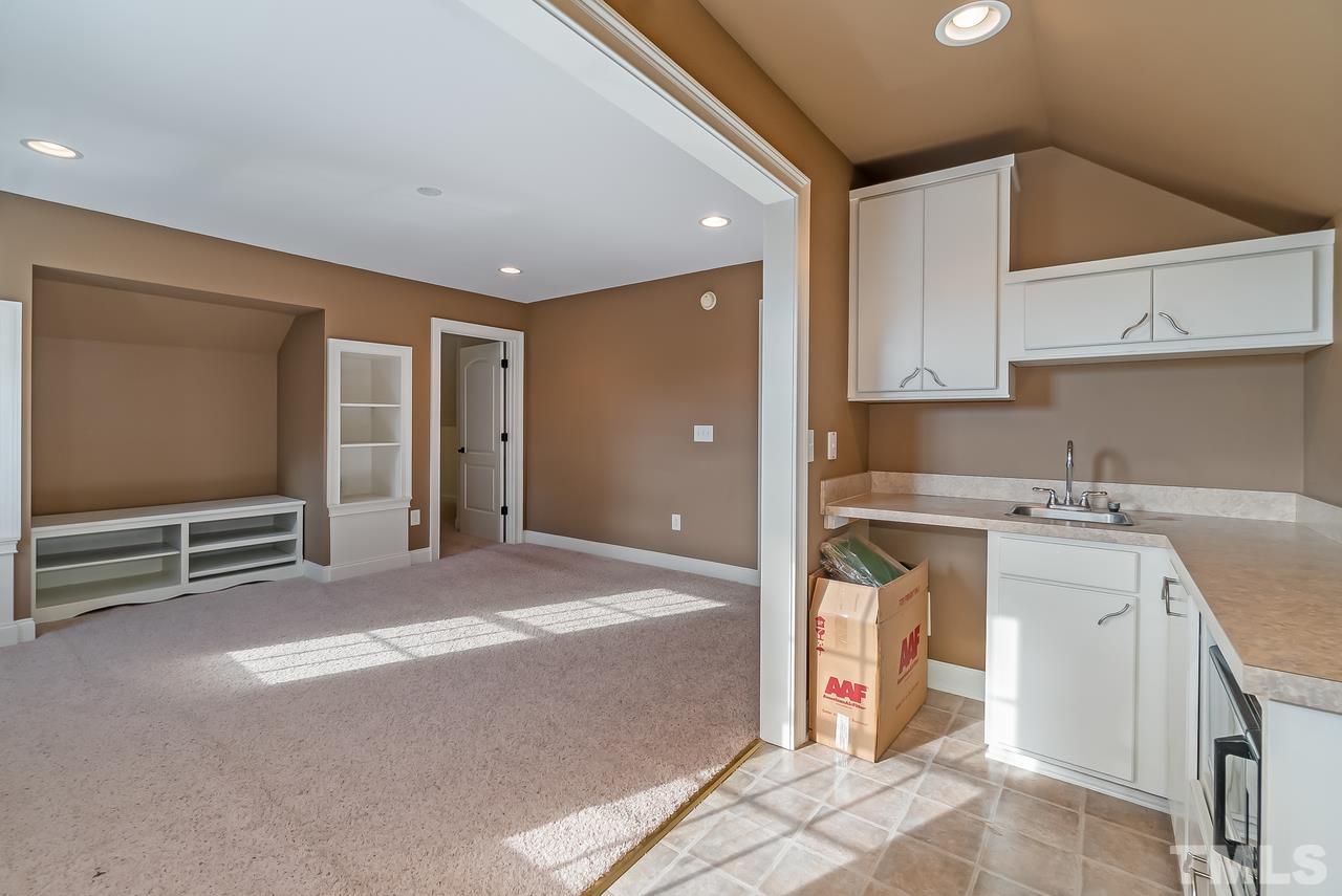 1313 Wynncrest Court Raleigh, NC 27603 - Photo 22 of 30 a living room with stainless steel appliances kitchen island granite countertop a sink and cabinets