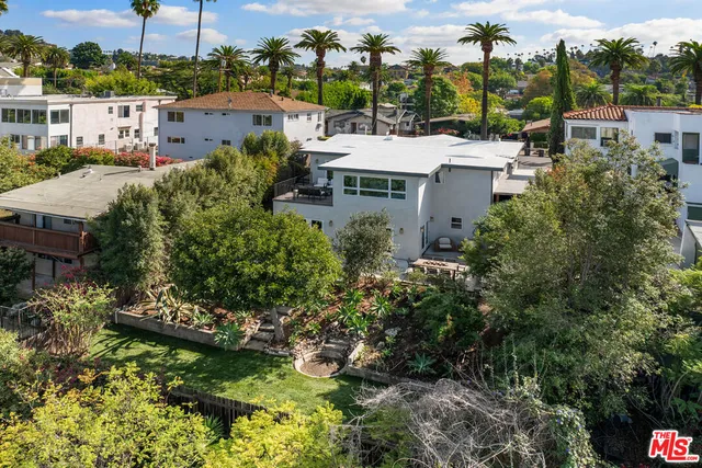 a view of a garden with a house