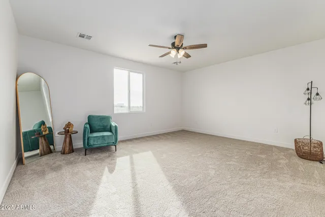 a view of a livingroom with furniture and a ceiling fan