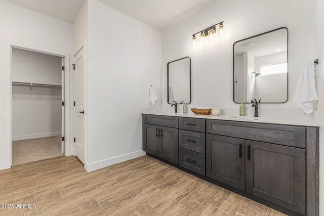 a spacious bathroom with double vanity sink and a mirror