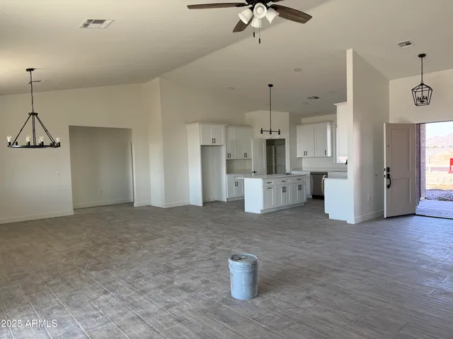 a view of a kitchen with a sink and refrigerator