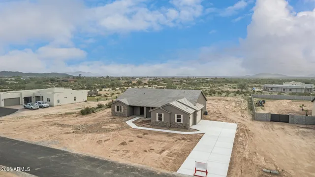 an aerial view of a house with outdoor space