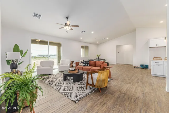 a living room with furniture a wooden floor and a window