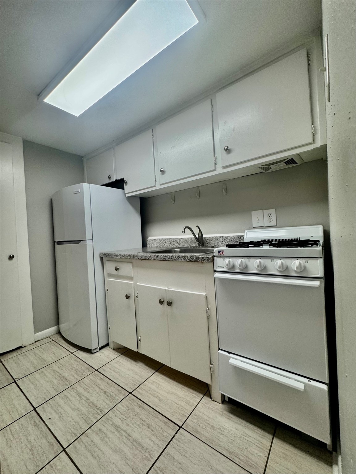 2006 Sul Ross Street, Unit 13 Houston, TX 77098 - Photo 6 of 13 a kitchen with cabinets and a refrigerator