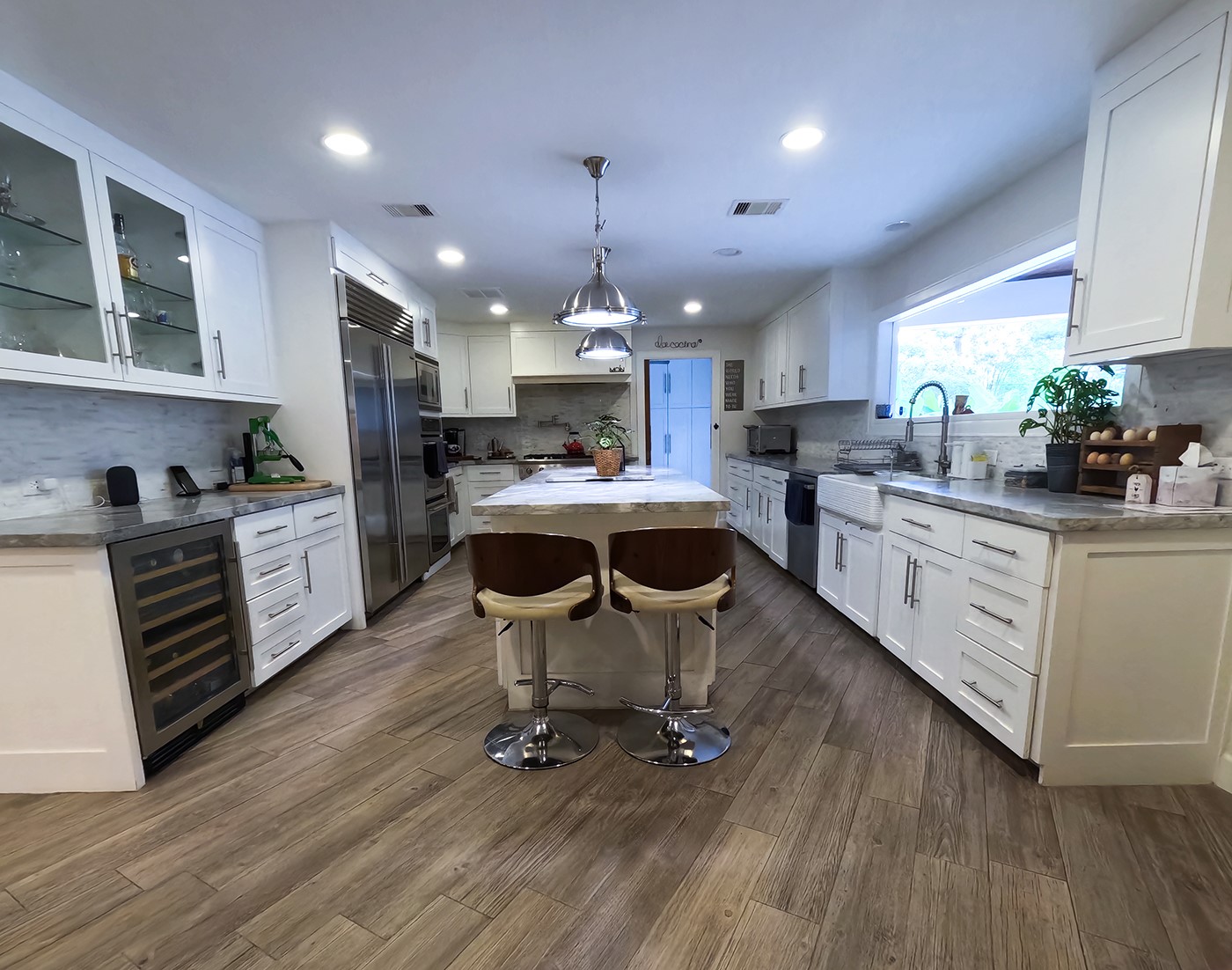9818 Shadow Wood Drive Houston, TX 77080 - Photo 7 of 36 a kitchen with sink cabinets and wooden floor