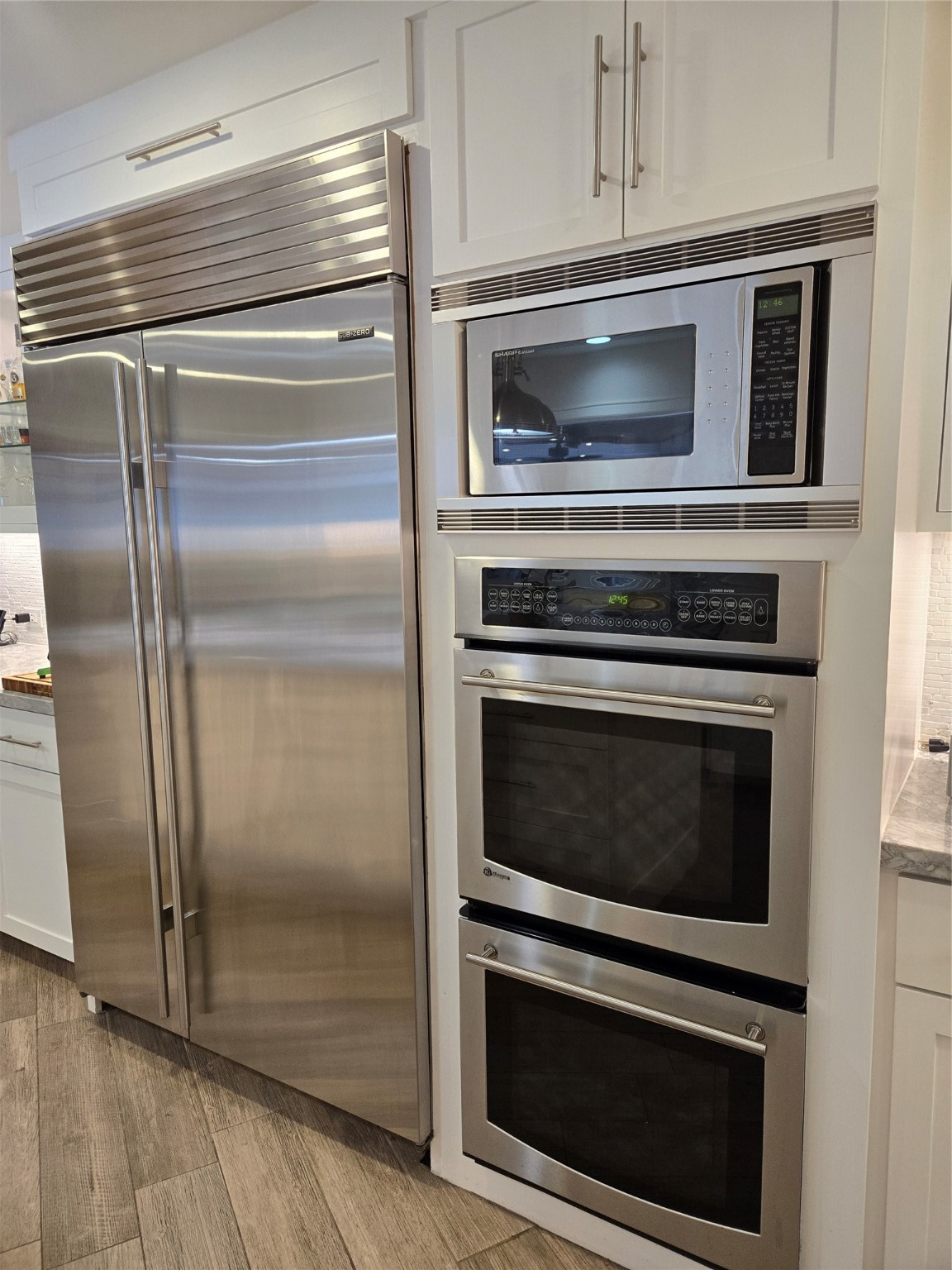 9818 Shadow Wood Drive Houston, TX 77080 - Photo 9 of 36 a kitchen with granite countertop stainless steel appliances and wooden floor