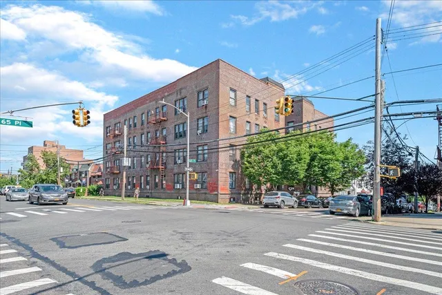 a view of a street with a building in the background