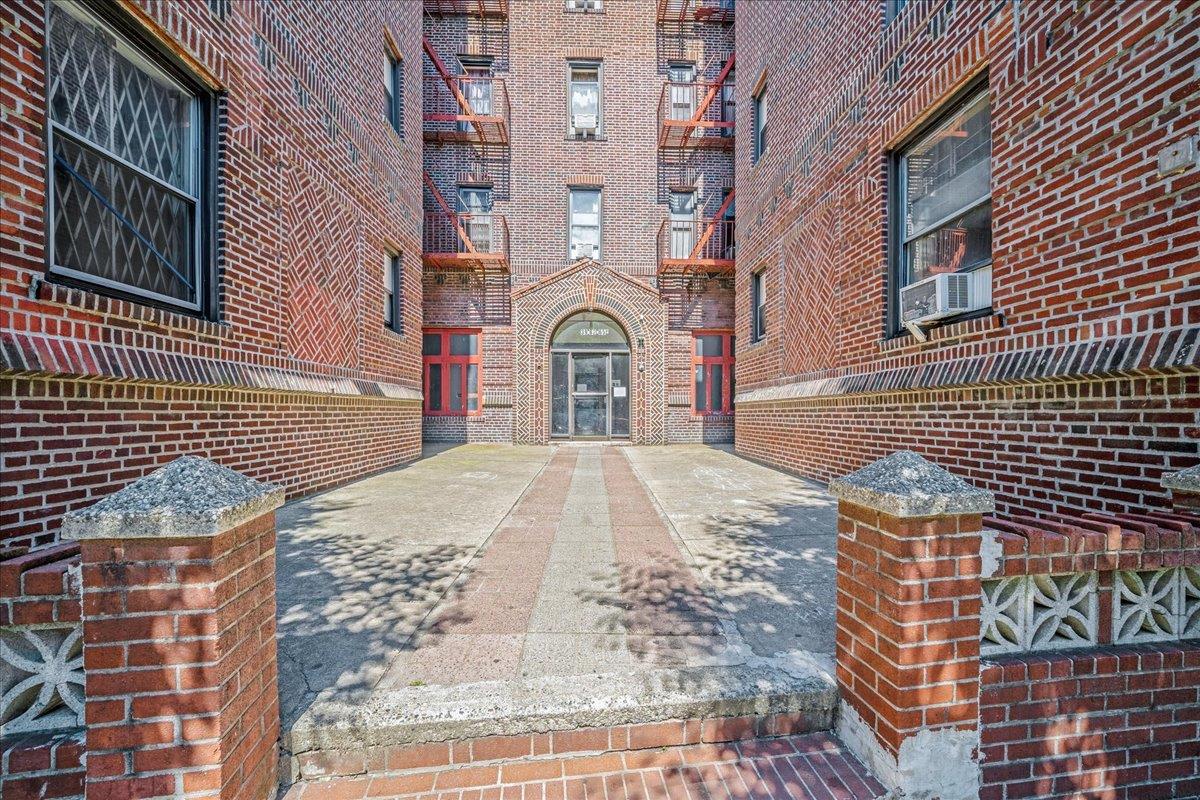 39-82 65th Place, Unit 4F Queens, NY 11377 - Photo 2 of 10 a view of a brick house with many windows