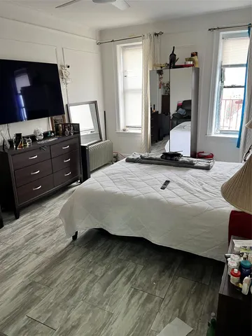 a bedroom with a bed and flat screen tv
