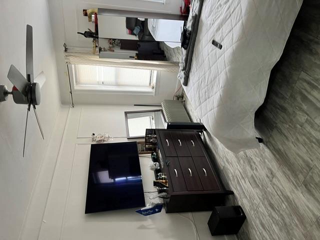 39-82 65th Place, Unit 4F Queens, NY 11377 - Photo 10 of 10 a bedroom with a bed and a flat screen tv