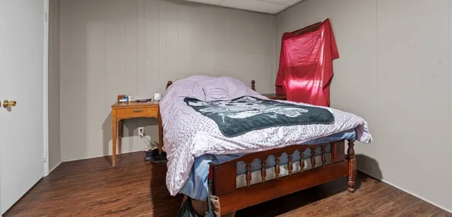 a bedroom with furniture and wooden floor