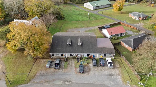 an aerial view of a house with garden space and street view