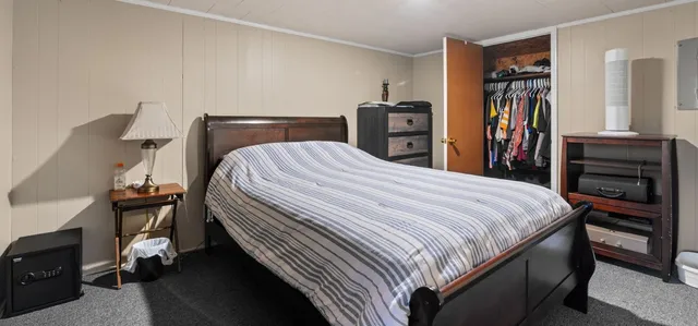 a bedroom with a bed and a closet