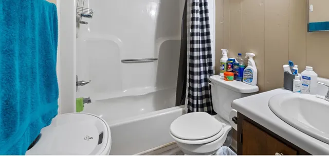 a bathroom with a sink toilet and shower