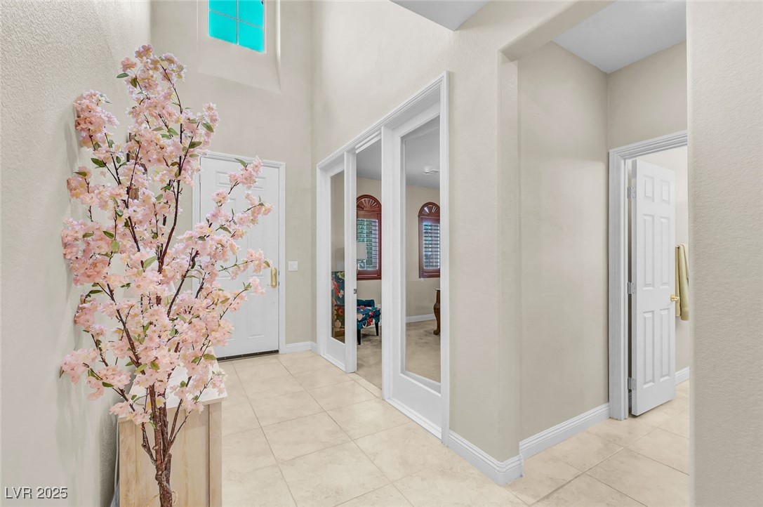 9725 Sandy Turtle Avenue Las Vegas, NV 89149 - Photo 23 of 51 Corridor with light tile patterned flooring and baseboards