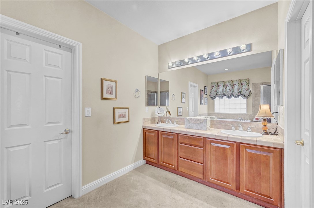 9725 Sandy Turtle Avenue Las Vegas, NV 89149 - Photo 32 of 51 Full bath featuring double vanity and baseboards